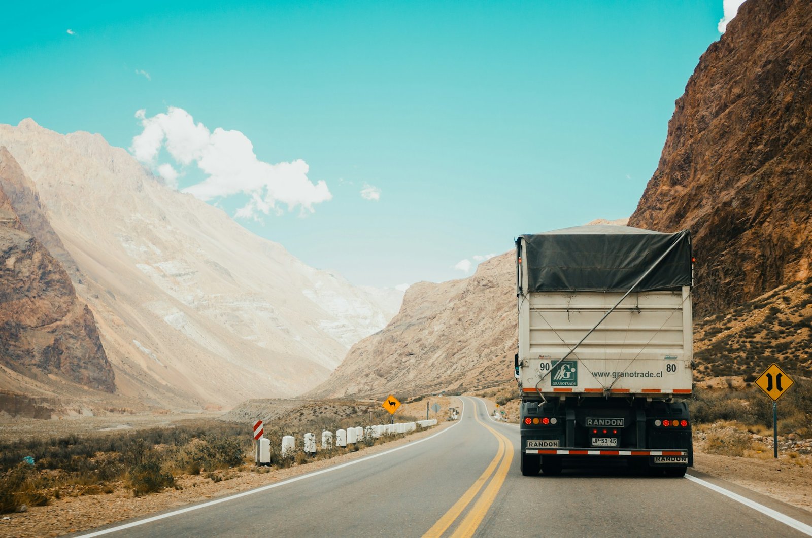 Trucks moving freight along a highway at dusk